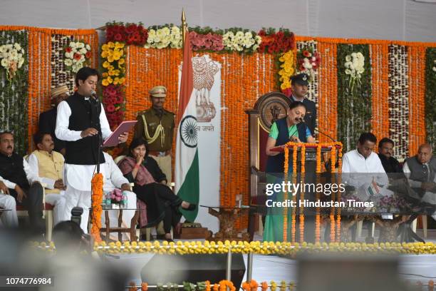 Madhya Pradesh Governor Anandiben Patel administers the oath of office to Cabinet Minister Jaivardhan Singh as Hukum Singh Karada seeks blessings of...