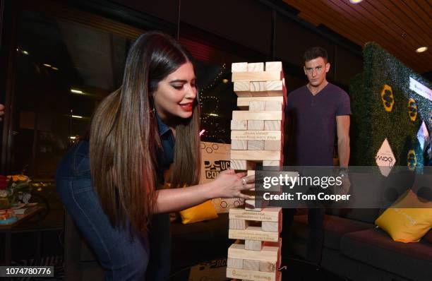 Host Denise Bidot and Blake Horstmann play jenga at the BumbleSpot #atthemoxy at Moxy Denver Cherry Creek on November 29, 2018 in Denver, Colorado.