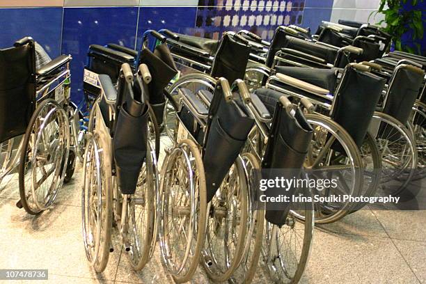 folded wheelchairs in airport - 車いす　無人 ストックフォトと画像