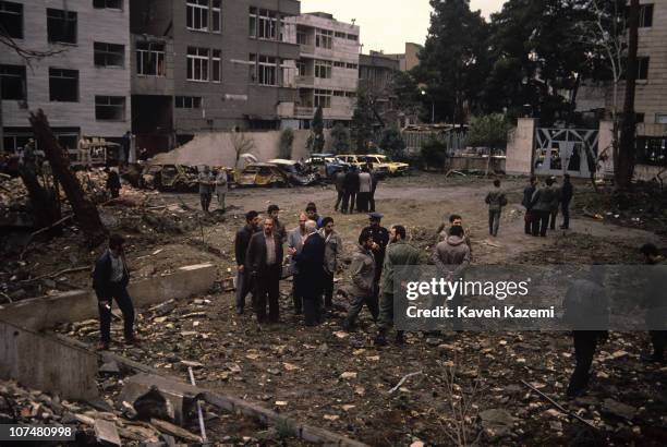 Security forces and experts gather on the site of an Iraqi missile strike on a residential area of Tehran, during the Iran-Iraq War, 20th February...