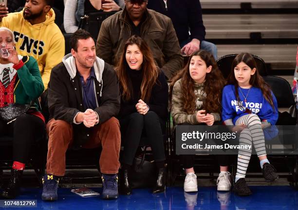 Adam Sandler, Jackie Sandler, Sadie Sandler and Sunny Sandler attend Milwaukee Bucks v New York Knicks game at Madison Square Garden on December 25,...