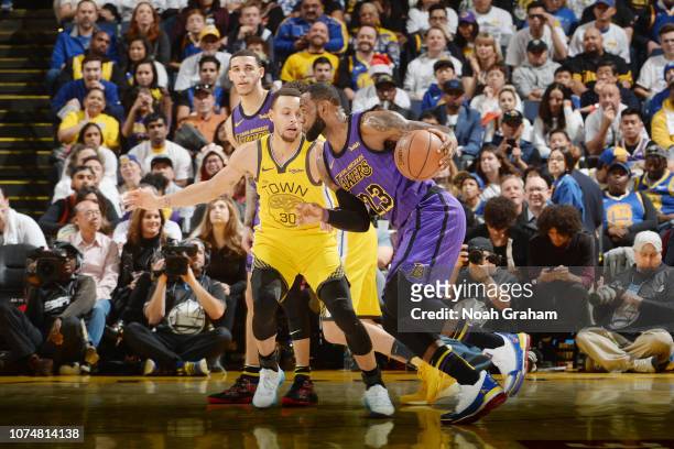 LeBron James of the Los Angeles Lakers handles the ball against Stephen Curry of the Golden State Warriors on December 25, 2018 at ORACLE Arena in...