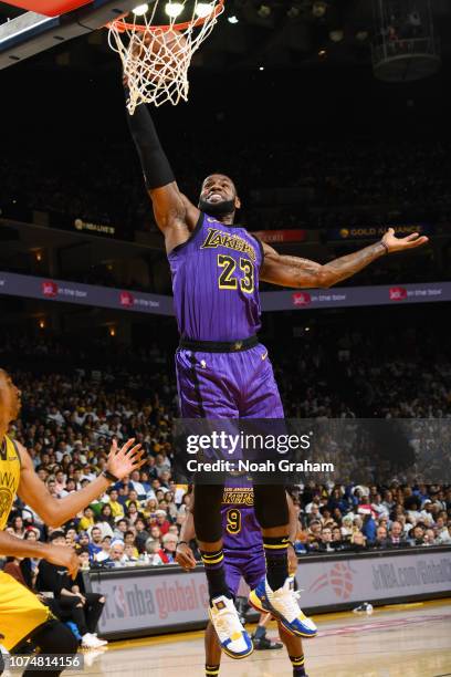 LeBron James of the Los Angeles Lakers dunks the ball against the Golden State Warriors on December 25, 2018 at ORACLE Arena in Oakland, California....