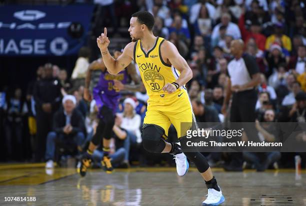 Stephen Curry of the Golden State Warriors celebrates after scoring over LeBron James of the Los Angeles Lakers during the first half of their NBA...