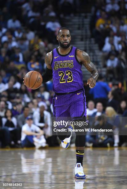 LeBron James of the Los Angeles Lakers dribbles the ball up court against the Golden State Warriors during the first half of their NBA Basketball...