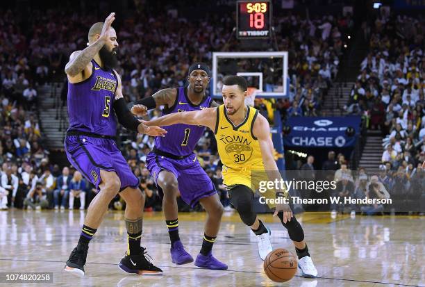 Stephen Curry of the Golden State Warriors drives on Tyson Chandler of the Los Angeles Lakers during the second half of their NBA Basketball game at...