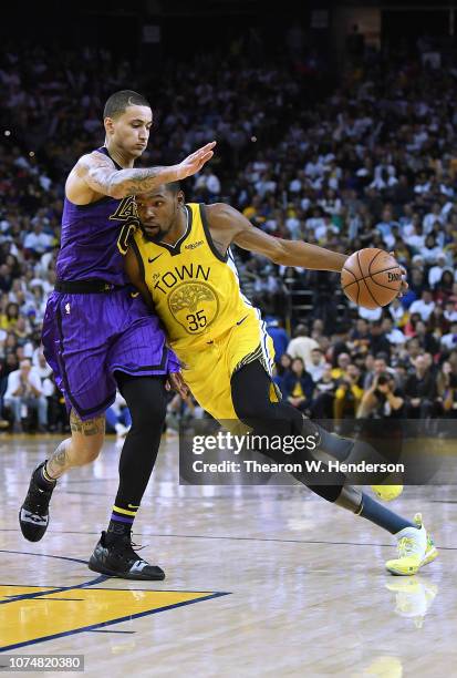 Kevin Durant of the Golden State Warriors drives to the basket on Kyle Kuzma of the Los Angeles Lakers during the second half of their NBA Basketball...