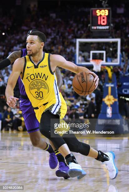 Stephen Curry of the Golden State Warriors drives towards the basket against the Los Angeles Lakers during the second half of their NBA Basketball...