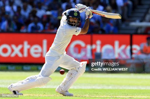 India's batsman Virat Kohli plays a shot during day one of the third cricket Test match between Australia and India in Melbourne on December 26,...