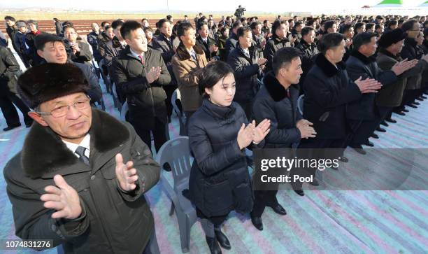 North Koreans attend the ceremony for a project to modernize and connect roads and railways over the border between the Koreas at Panmun Station on...