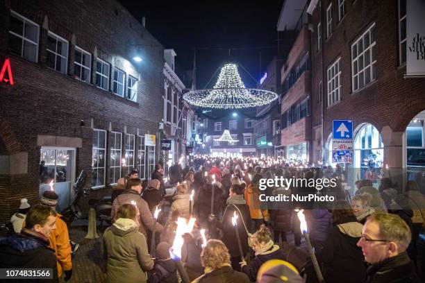 Fakkeltocht or Torchlight procession in Christmas Eve for Peace in Eindhoven city, The Netherlands. The flame in the torches comes from The World...