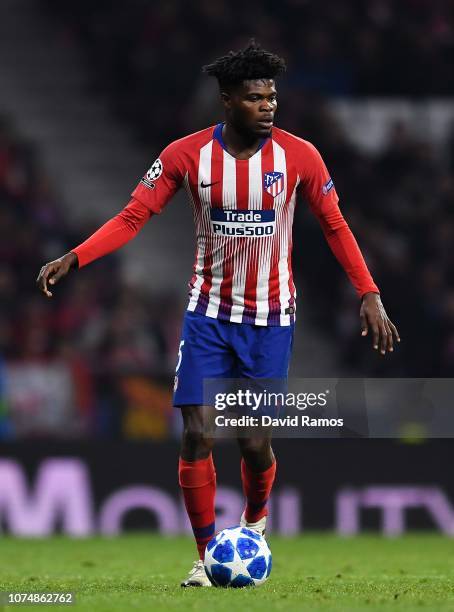 Thomas Partey of Club Atletico de Madrid runs with the ball during the Group A match of the UEFA Champions League between Club Atletico de Madrid and...