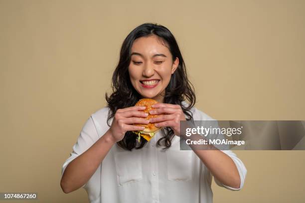 a young asian girl is eating - auckland food bildbanksfoton och bilder