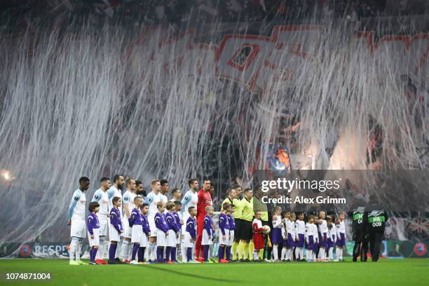 The two teams line up prior to the UEFA Europa League Group H match between Eintracht Frankfurt and Olympique de Marseille at Commerzbank-Arena on...