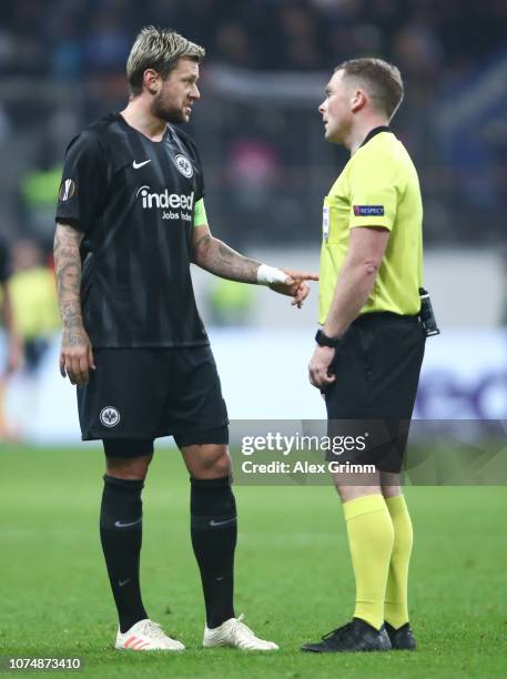 Marco Russ of Frankfurt talks to referee John Beaton reacts during the UEFA Europa League Group H match between Eintracht Frankfurt and Olympique de...