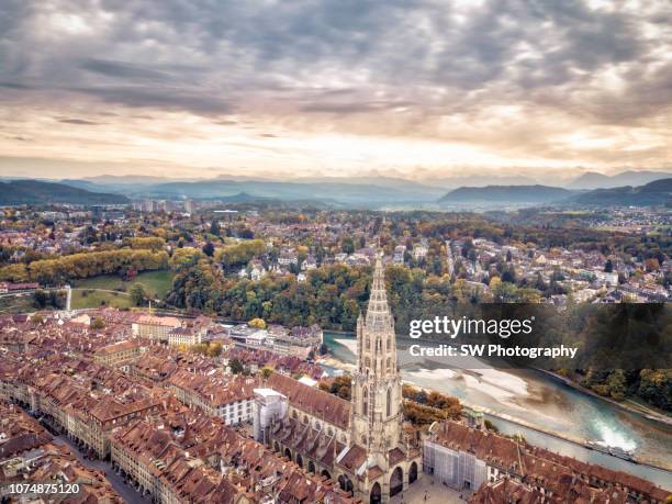 drone photo of bern minister and the bern cityscape - bern stock-fotos und bilder