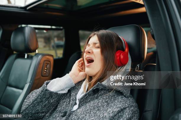 woman enjoy her self-drive car - car listening to music imagens e fotografias de stock