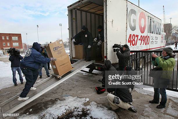Movers load the possessions of Annie Ricks and her family into a moving truck after she was forced to leave the Cabrini-Green public housing complex...