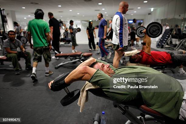 Men work out in the weight room at the NATO gym December 7, 2010 in Kandahar, Afghanistan.There are 16,000 NATO troops in Kandahar province and...