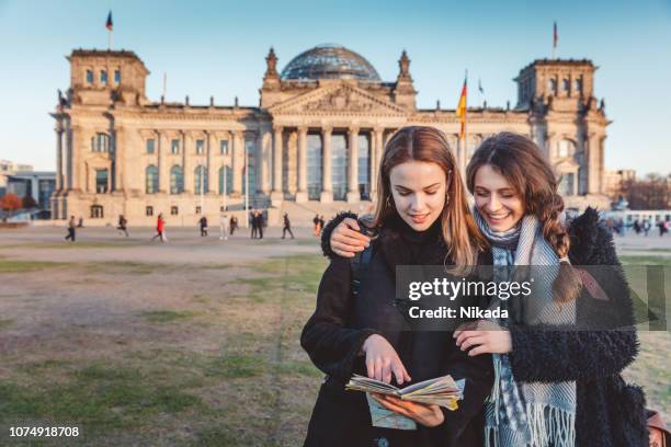 tourist in berlin reading the tourist map - berlin travel stock pictures, royalty-free photos & images