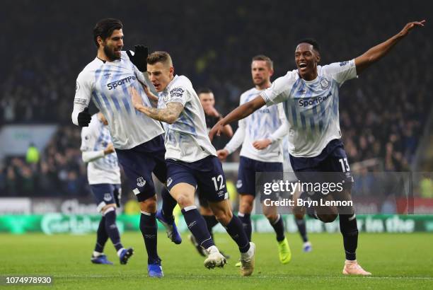 Lucas Digne of Everton celebrates after scoring his team's second goal with Yerry Mina and Andre Gomes during the Premier League match between...