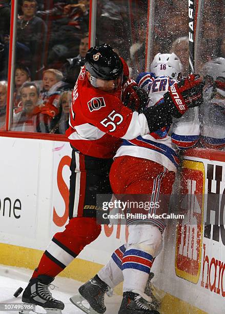 Sergei Gonchar of the Ottawa Senators runs Sean Avery of the New York Rangers into the end boards at Scotiabank Place on December 9, 2010 in Ottawa,...