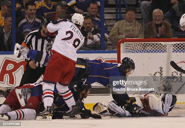 Crombeen of the St. Louis Blues is dumped by Nikita Filatov of the Columbus Blue Jackets at the Scottrade Center on December 9, 2010 in St Louis,...