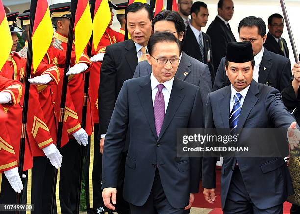 Malaysia's King Sultan Mizan Zainal Abidin escorts South Korean President Lee Myung Bak at an official welcoming ceremony at Parliament house in...