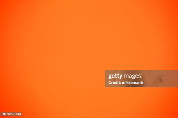 shot of orange colored paper background - オレンジ ストックフォトと画像