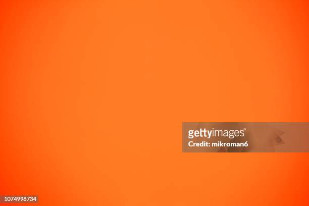 shot of orange colored paper background - abstract color background stockfoto's en -beelden