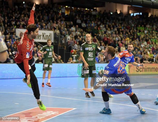 Silvio Heinevetter of the Fuechse Berlin and Nico Buedel of HC Erlangen during the Handball-Bundesliga game between the Fuechse Berlin and the HC...