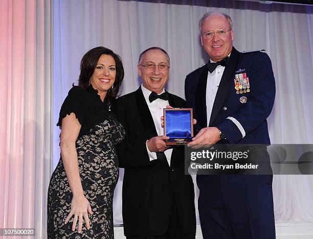 News Anchor Kyra Phillips, Steve Scheffer and Chief of the National Guard Bureau General Craig R. McKinley pose onstage at the 49th USO Armed Forces...