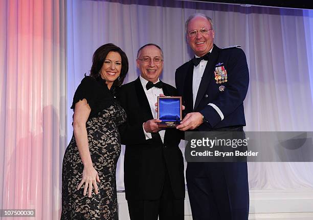 News Anchor Kyra Phillips, Steve Scheffer and Chief of the National Guard Bureau General Craig R. McKinley pose onstage at the 49th USO Armed Forces...