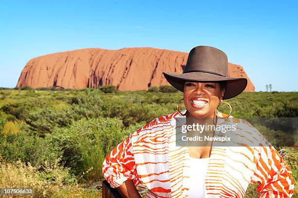 Oprah Winfrey poses in front of Ayres Rock during a tour to Uluru on December 9, 2010 in Uluru, Australia. . Oprah Winfrey is in Australia with 302...