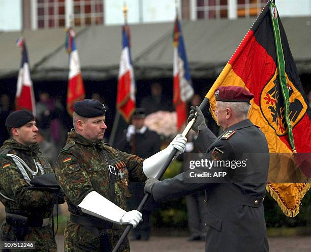 German General Werner Freers is offered the flag of the squadron during a ceremony in the eastern French city of Strasbourg on December 10 to mark...