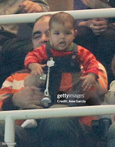 Jose Andrade holds Cristiano Ronaldo's son, Cristiano Ronaldo jr during the Champions League group G match between Real Madrid and AJ Auxerre at...