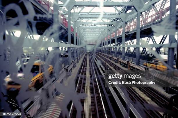 view of railroad tracks on the manhattan bridge from rear mirror of subway car in new york city - lower east side manhattan stock pictures, royalty-free photos & images