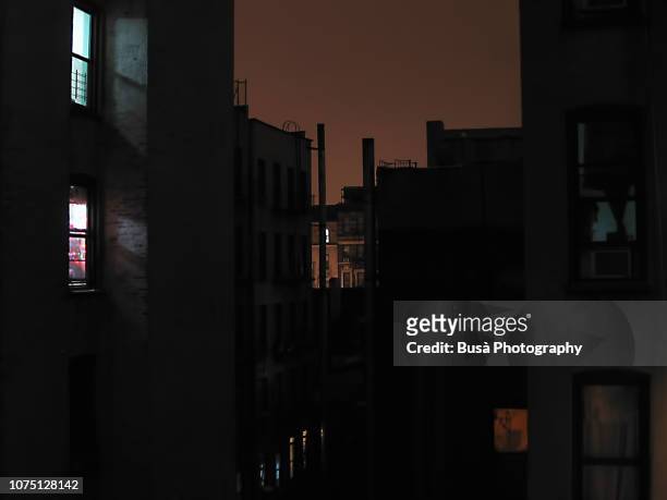 night view between tenement buildings in manhattan - poor area stock-fotos und bilder