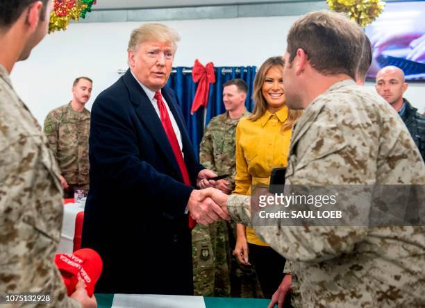 President Donald Trump and First Lady Melania Trump greet members of the US military during an unannounced trip to Al Asad Air Base in Iraq on...