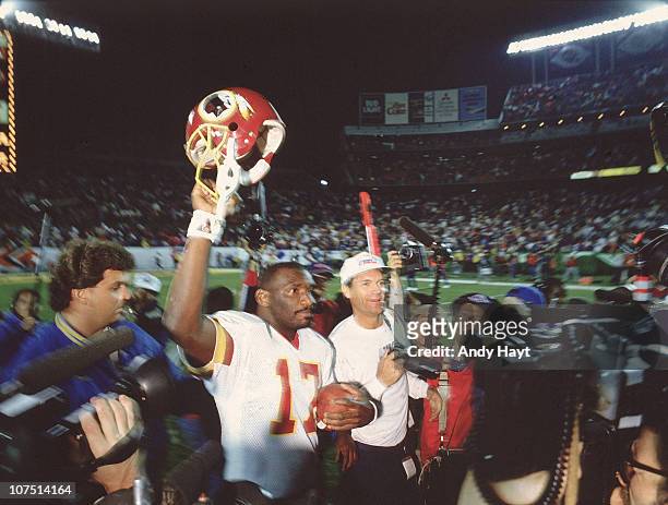 Super Bowl XXII: Washington Redskins QB Doug Williams victorious, walking off field during celebration after winning game vs Denver Broncos at Jack...