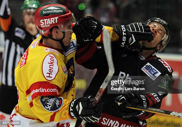 Patrick Reimer of Duesseldorf punshes Mike Card of Koeln during the DEL match between Koelner Haie and DEG Metro Stars at Lanxess Arena on December...