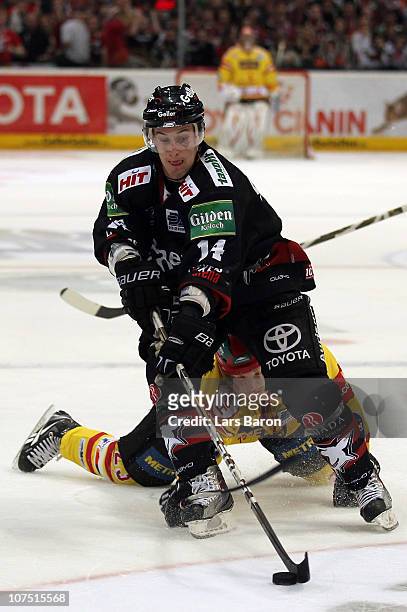 James Sixsmith of Koeln is challenged by Daniel Kreutzer of Duesseldorf during the DEL match between Koelner Haie and DEG Metro Stars at Lanxess...