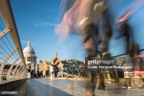 st paul's cathedral and blurred commuters on the millennium bridge, london - millennium bridge londra foto e immagini stock