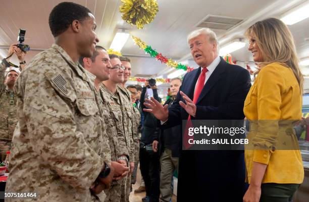 President Donald Trump and First Lady Melania Trump greet members of the US military during an unannounced trip to Al Asad Air Base in Iraq on...
