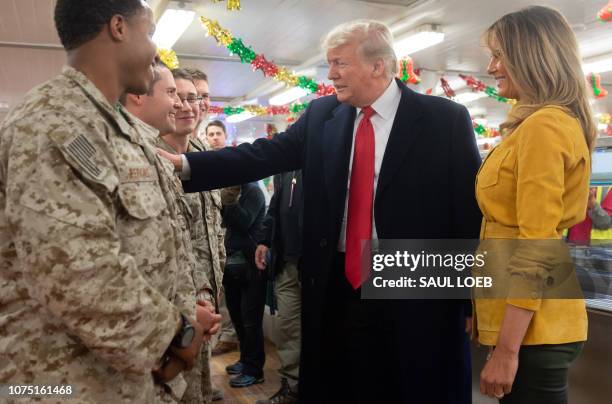 President Donald Trump and First Lady Melania Trump greet members of the US military during an unannounced trip to Al Asad Air Base in Iraq on...