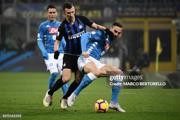 Napoli's Serbian defender Nikola Maksimovic holds off Inter Milan's Croatian midfielder Ivan Perisic during the Italian Serie A football match Inter...