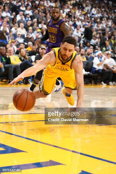 Klay Thompson of the Golden State Warriors dives for a loose ball against the Los Angeles Lakers on December 25, 2018 at ORACLE Arena in Oakland,...