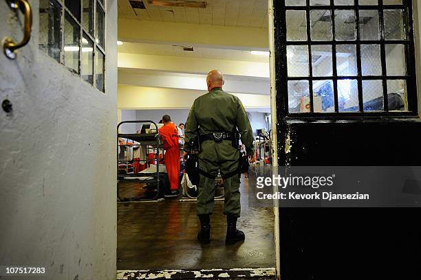 California Department of Corrections officer speaks to inmates at Chino State Prison in the dayroom of Sycamore Hall that was modified to house...