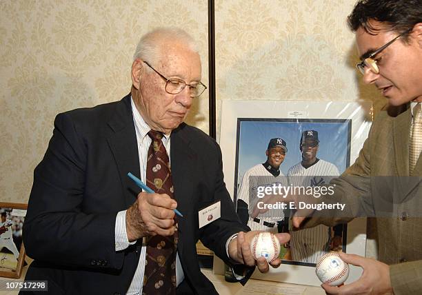 Bob Feller, signs autographs at The 6th Annual Major League Baseball Players Alumni Dinner, ath the Hilton New York, on November 18, 2005
