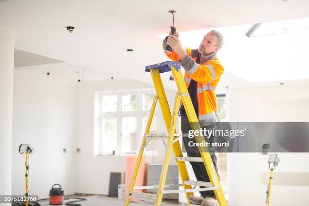 electrician installing downlights - recessed lighting ceiling stock pictures, royalty-free photos & images